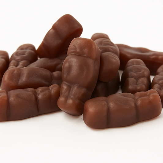 Chocolate-flavoured soft candy pieces shaped like small baby bottles, stacked on a white background.