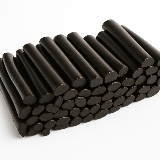 “High-quality photo of glossy black licorice logs neatly stacked on a clean white background, showing their smooth, shiny texture.”