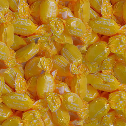 Yellow candies with white polka dots and text in a close-up shot.
