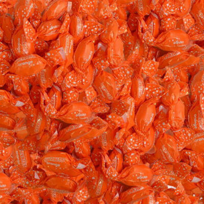 Close-up of numerous orange candy wraps with visible branding.