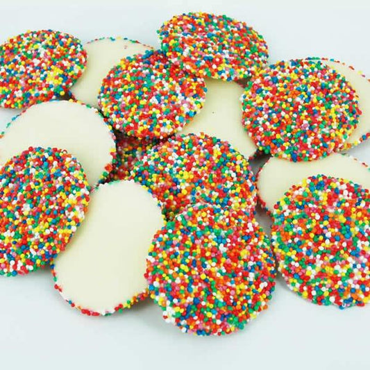 Large round white chocolate discs topped with colourful hundreds and thousands, displayed on a clean white background.