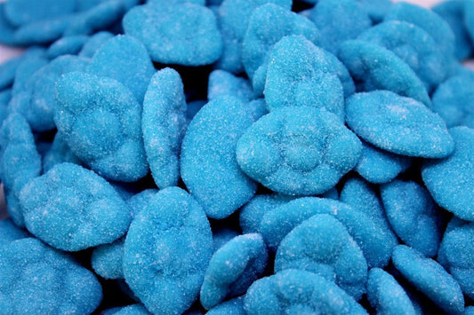 Soft blue and white sugar-coated blueberry cloud lollies with a fluffy texture, piled together on a white background.