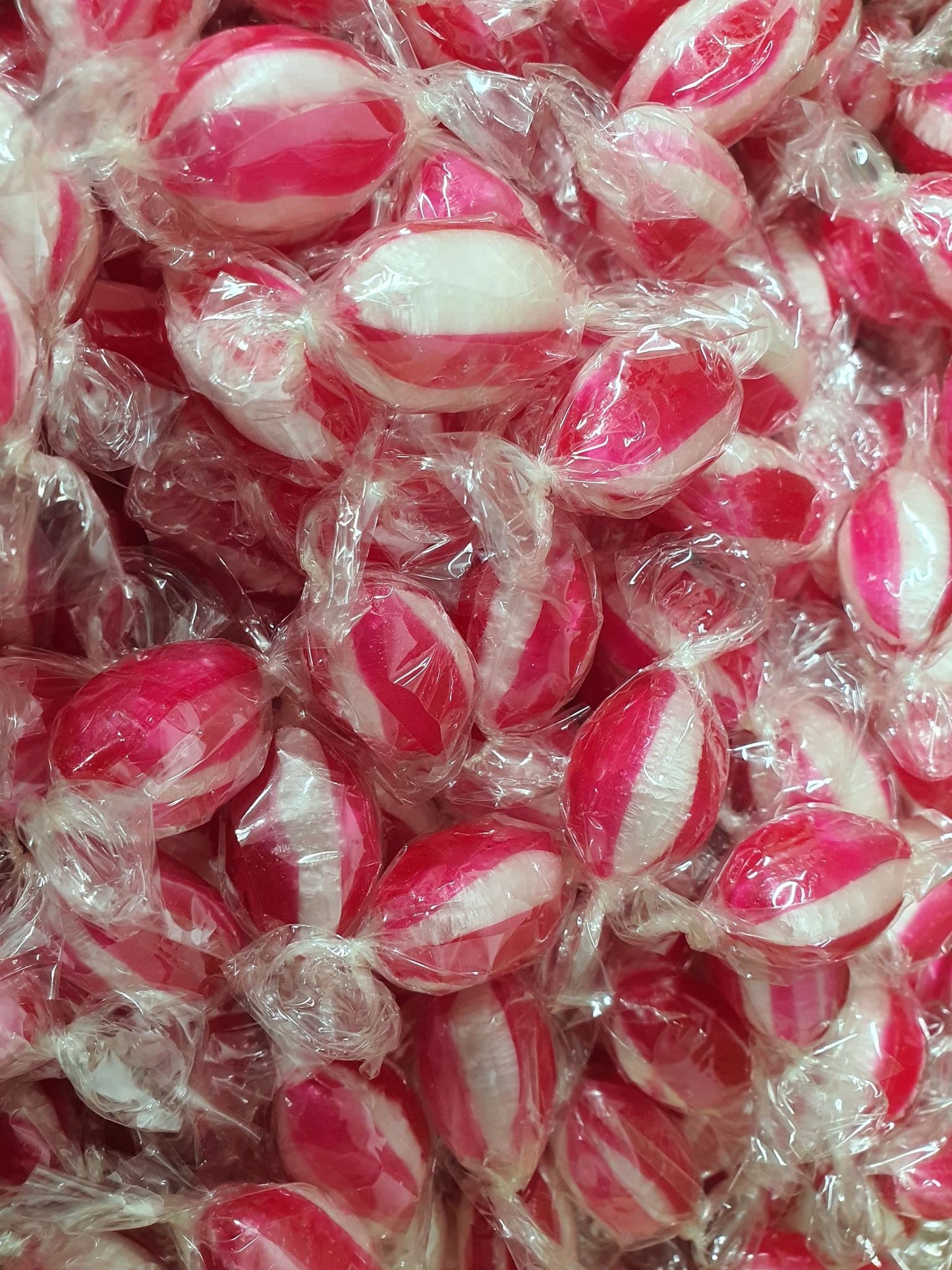 Close-up of red and white bullseye hard candies individually wrapped in clear cellophane,