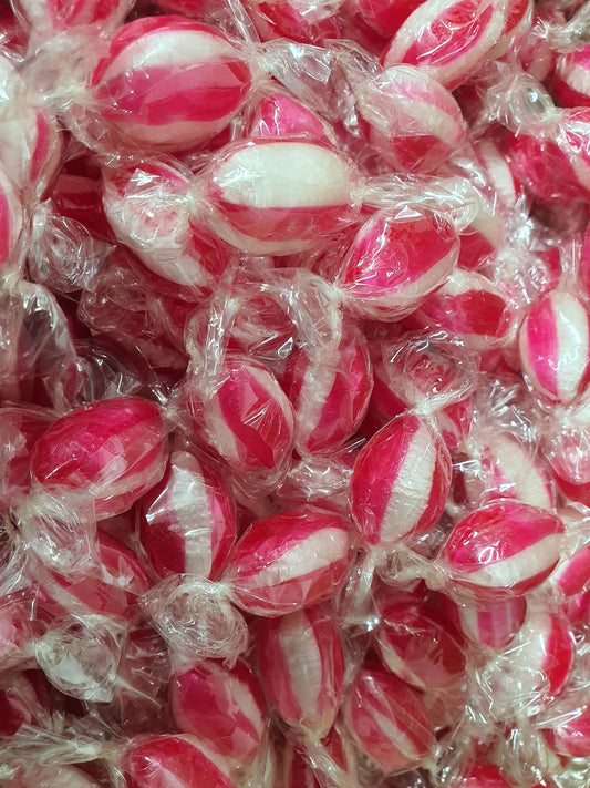 Close-up of red and white bullseye hard candies individually wrapped in clear cellophane,