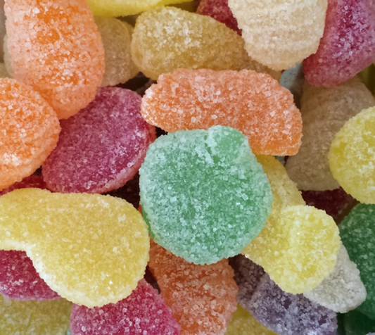 Assorted sugar-coated fruit jellies in bright colours including orange, green, yellow, red, and purple, displayed on a white background.