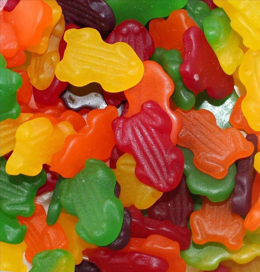 Colourful gummy frog-shaped lollies in red, green, yellow, and orange displayed together on a white background.