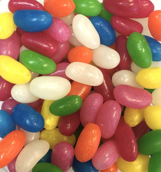 Colourful jelly beans in assorted flavours, including red, blue, green, yellow, orange, and white, displayed on a white background.
