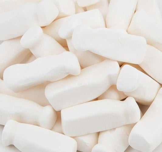 Soft, white milk bottle-shaped lollies displayed on a white background, showing smooth and chewy foam texture.