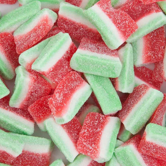 “Close-up of colourful watermelon slice lollies coated in a layer of sugar crystals, featuring red and green gummy candy pieces on a white background.”