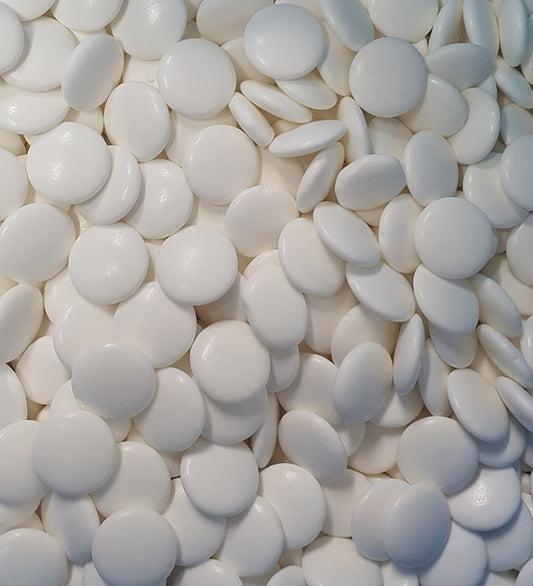 “Close-up of glossy white extra strong peppermint candies with a smooth shiny surface, neatly arranged on a clean white background.”