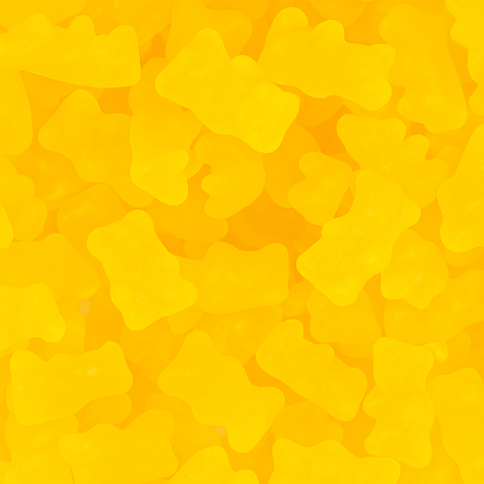 “Close-up of bright yellow honey bear gummy candies with a glossy, soft texture on a white background.”