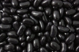 “Close-up image of glossy black jelly beans with a smooth coating and chewy texture, displayed on a white background.”