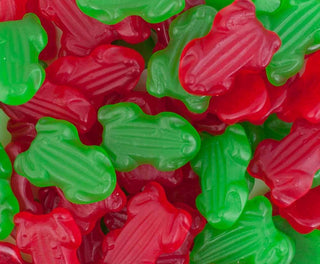Red and green gummy frog-shaped lollies displayed on a white background, showing their soft, chewy texture and glossy finish.