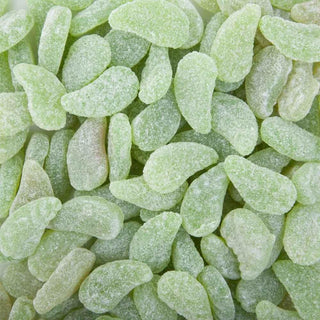 Soft green mint leaf-shaped lollies coated in sugar, displayed on a white background showing their chewy and glossy texture.