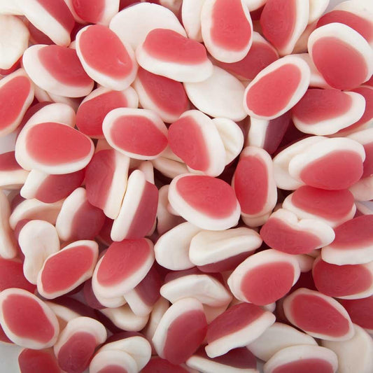Soft pink and white strawberry and cream lollies displayed on a white background, showing their chewy foam texture and smooth glossy finish.
